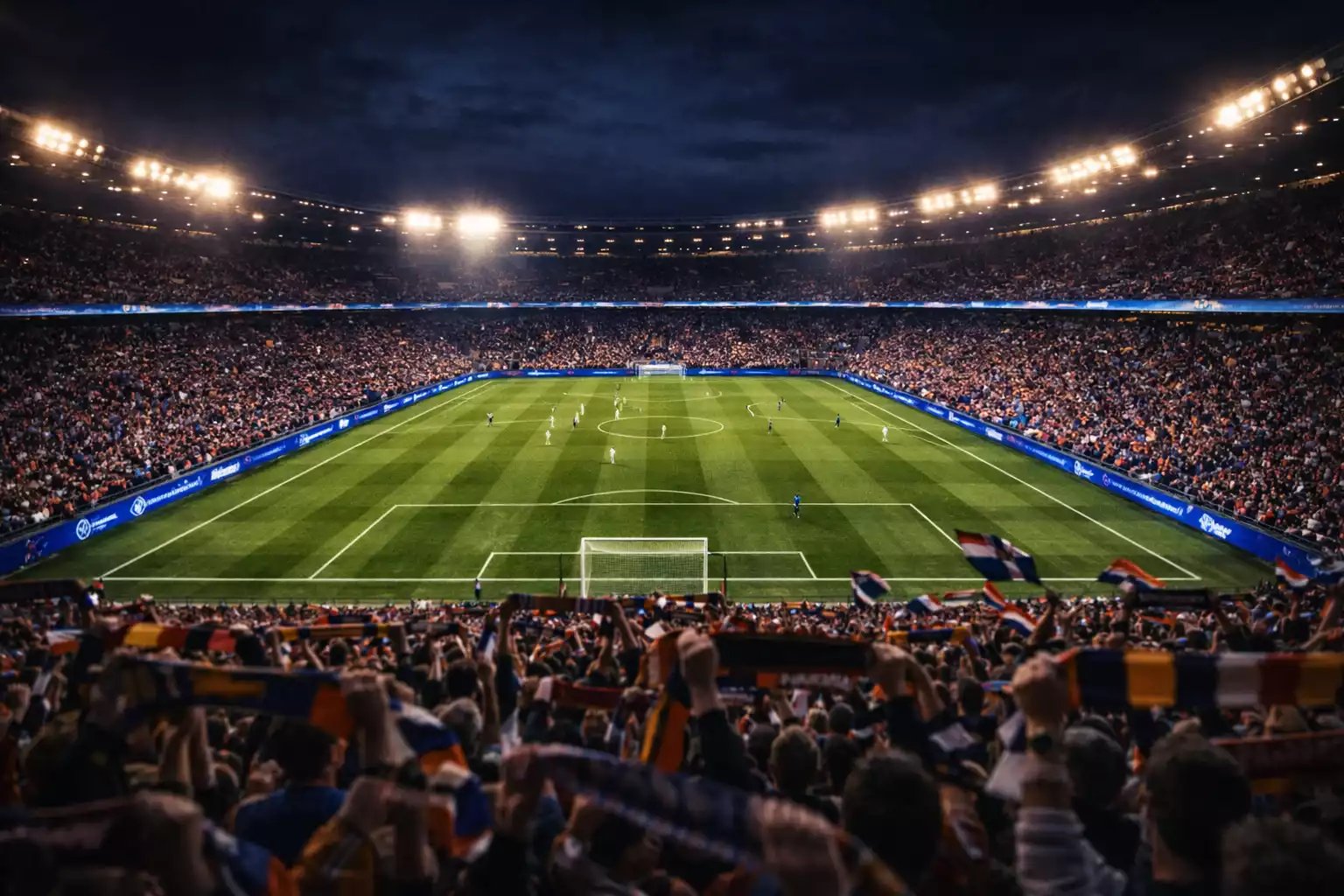 Verlicht voetbalstadion tijdens Champions League avondwedstrijd met volle tribunes